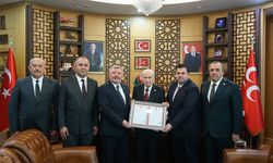 Parti binasının tapusunu Bahçeli’ye takdim ettiler